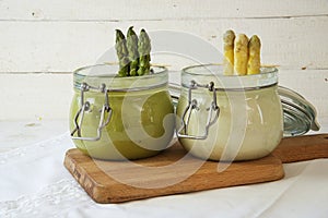 Asparagus cream soup white and green creatively served in glass