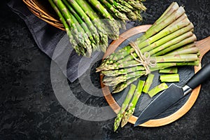 Asparagus. Fresh raw organic green Asparagus sprouts closeup. On black table background. Healthy vegetarian food