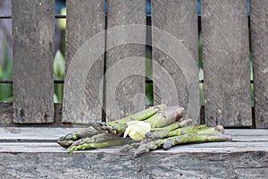 Asparagus with metallic lattice, wooden surface