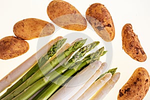 Asparagus and potatos isolated on white background