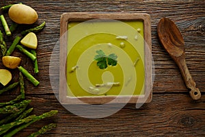 Asparagus soup green cream on aged wood table