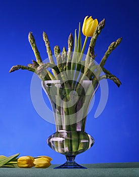 Asparagus in the spring is illustrated with a photo of asparagus and tulips in a vase