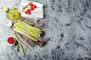 Asparagus and tomatoes on rusticbackground