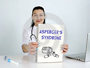 ASPERGER`S SYNDROME text in menu. Neurologist looking for something at laptop