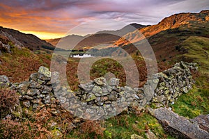 Asperitas clouds at sunrise with beautiful light on mountains. Side Pike, Lake District, UK.