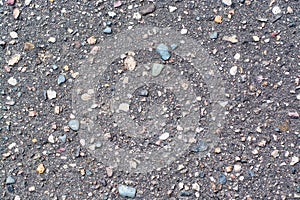 Asphalt background gray with splashes of stones and cracks