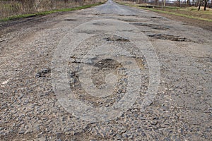 Asphalt bad broken road with pits