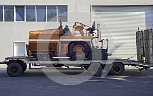 Asphalt bitumen paver and an truck with trailer.