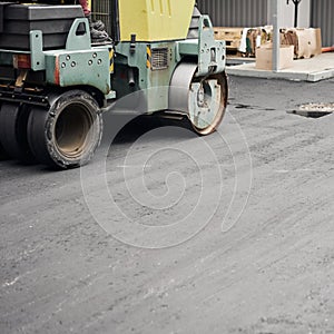 Asphalt Compactors is carrying out road repair work. Laying new asphalt. Large heavy machinery. Construction of a new