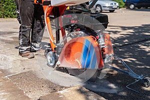 The road is sawn open with asphalt and a concrete saw.