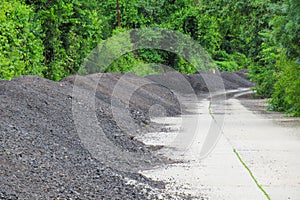 Asphalt deposits on the road, near the forest photo