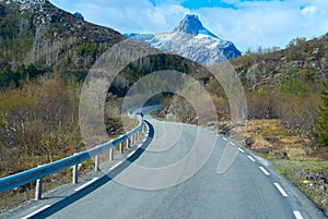 Asphalt gray road in Norvegian mountains photo