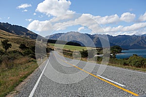 Asphalt highway curve road to mountain cook New Zealand with clo