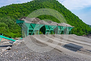 Asphalt hot mix plant. asphalt plant cold aggregate feed system. container with sand and aggregate - stone dust in the correct pro