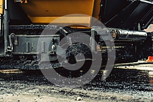 Asphalt laying machines