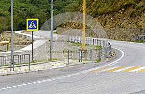 Asphalt mountain road with pedestrian crossing