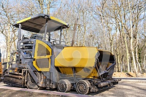 Asphalt paver on construction site ready for work