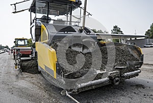 Asphalt paver machine during road construction and repairing works. A paver finisher, asphalt finisher or paving machine