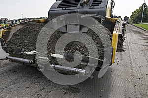 Asphalt paver machine during road construction and repairing works. A paver finisher, asphalt finisher or paving machine