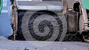 Asphalt paver machine during road construction, road construction crew apply asphalt layer