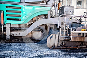 Asphalt paver machine during road construction site