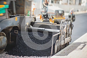 Asphalt paver machine and steam road roller during road construction and repairing works, process of asphalting and paving,