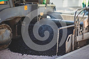 Asphalt paver machine and steam road roller during road construction and repairing works, process of asphalting and paving,