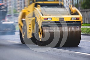 Asphalt paver machine and steam road roller during road construction and repairing works, process of asphalting and paving,