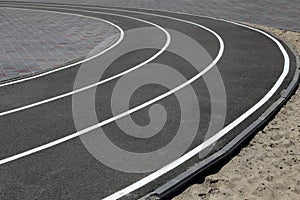 Asphalt racetrack on a stadium, abstract sports background