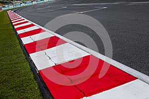 Asphalt red and white kerb of a race track detail