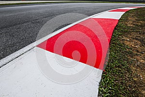 Asphalt red and white kerb of a race track detail