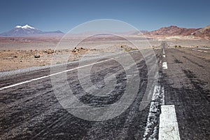 Asphalt road in Atacama desert, volcanic arid landscape in Chile, South America