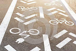 Asphalt road with bicycle and electric transport lane. Cycle and zero emission vehicles white sign on floor. Recreation area for