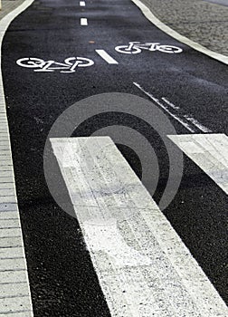 Asphalt road with bicycles inscription along markings