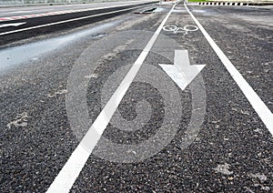 asphalt road and bike lane with sign