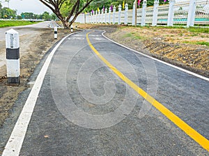 asphalt road and bike lane with sign