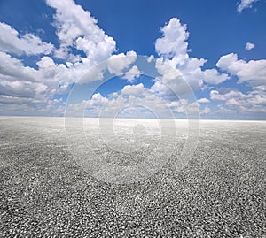 Asphalt road and blue sky with white clouds.