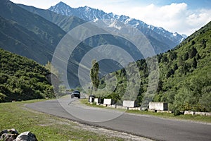 asphalt road with car in high mountains