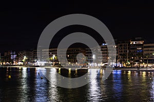 Asphalt road and city skyline with modern building at night. sea evening landscape