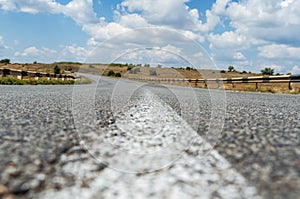 Asphalt road closeup with center white line