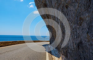 Asphalt road. Colorful landscape with beautiful mountain road with a perfect asphalt. High rocks, blue sky at sunrise in