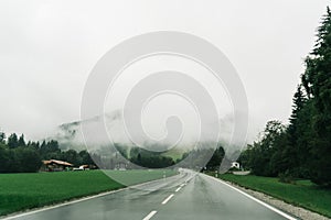 Asphalt road through countryside in rainy day