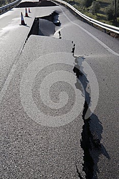 Asphalt road with a crack caused by landslides