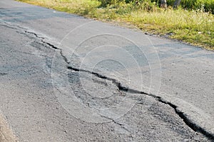 asphalt road cracked due to moving ground. earthquake.