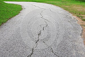 Asphalt road cracked. street in public park