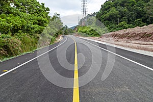 Asphalt road curve with yellow line on road