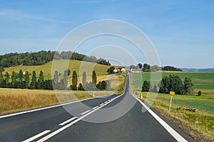 Asphalt road cutting through the rural landscape