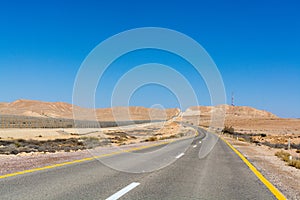 Asphalt road in desert Negev, Israel, road 40, transport infrastructure in desert, scenic mountains route from Eilat to north