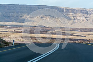 Asphalt road in desert Negev, Israel, road 40, transport infrastructure in desert, scenic mountains route in Mizpe Ramon canyon i