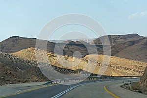 Asphalt road in desert Negev, Israel, road 40, transport infrastructure in desert, scenic mountains route in Mizpe Ramon canyon i